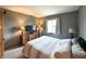 Comfortable bedroom with neutral walls, carpet flooring, and bright window at 5967 Oak Hill East Dr, Plainfield, IN 46168