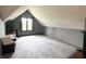 An open bonus room with plush carpeting and a picture window for ample natural lighting at 5967 Oak Hill East Dr, Plainfield, IN 46168