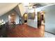 An open bonus room with hardwood flooring and an adjacent office space and modern ceiling fan at 5967 Oak Hill East Dr, Plainfield, IN 46168
