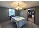 Cozy dining room with carpet, chandelier, and a view of the deck and backyard at 5967 Oak Hill East Dr, Plainfield, IN 46168
