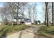 Charming two-story home with a long driveway and mature trees in the front yard at 5967 Oak Hill East Dr, Plainfield, IN 46168