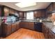 Kitchen featuring dark wood cabinets, granite countertops, and stainless steel appliances at 5967 Oak Hill East Dr, Plainfield, IN 46168