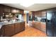 Spacious kitchen with wood cabinets, granite countertops, and a view to the living room at 5967 Oak Hill East Dr, Plainfield, IN 46168