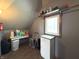 Laundry room with overhead storage, small side-table, and neutral colored flooring at 5967 Oak Hill East Dr, Plainfield, IN 46168