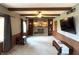 Cozy living room with a stone fireplace, wood beams, and neutral carpeting at 5967 Oak Hill East Dr, Plainfield, IN 46168