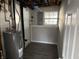 This basement utility room includes a new water heater and updated gray walls at 6044 Granner Dr, Indianapolis, IN 46221