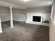 This carpeted basement includes a decorative white brick fireplace at 6044 Granner Dr, Indianapolis, IN 46221