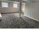 This carpeted basement offers updated gray paint, trim and windows at 6044 Granner Dr, Indianapolis, IN 46221