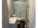 This bathroom offers a shower with glass doors, white vanity, new toilet and gray walls at 6044 Granner Dr, Indianapolis, IN 46221