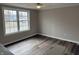 Bright bedroom with a large window and dark floors, providing natural light at 6044 Granner Dr, Indianapolis, IN 46221