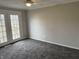 Bedroom features doors to the outside, neutral walls, ceiling fan, and carpeted floors at 6044 Granner Dr, Indianapolis, IN 46221