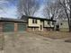 Traditional home with brick accents, attached garage, and a well-maintained front yard at 6044 Granner Dr, Indianapolis, IN 46221