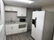 This kitchen includes white cabinets, modern appliances and updated sink at 6044 Granner Dr, Indianapolis, IN 46221