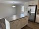 Kitchen island with drawers and stainless steel refrigerator in updated kitchen at 6044 Granner Dr, Indianapolis, IN 46221