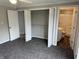 Bedroom with closet and bathroom entrances, carpeting, and neutral walls at 6044 Granner Dr, Indianapolis, IN 46221