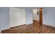 Bedroom featuring wood floors, closet, and an open door to another room at 6515 Park Central Way # B, Indianapolis, IN 46260