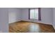 Bedroom featuring laminate floors and a window with purple curtains at 6515 Park Central Way # B, Indianapolis, IN 46260