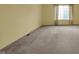 Spacious bedroom with large window and neutral carpet at 6515 Park Central Way # B, Indianapolis, IN 46260
