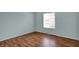 This bedroom features a wood floor and a bright window with natural light at 6515 Park Central Way # B, Indianapolis, IN 46260