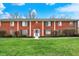 Charming brick townhome with a well-manicured lawn and inviting blue front door at 6515 Park Central Way # B, Indianapolis, IN 46260