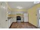 Functional kitchen featuring neutral walls, appliances, cabinets, and a window for natural light at 6515 Park Central Way # B, Indianapolis, IN 46260