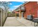 Back patio view of a brick townhouse with a balcony and a privacy fence at 6515 Park Central Way # B, Indianapolis, IN 46260