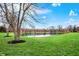 Tranquil pond view with buildings as the backdrop offers a peaceful and scenic community setting at 6515 Park Central Way # B, Indianapolis, IN 46260