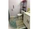 Well-lit bathroom with a modern vanity, toilet, and stylish decorative mats at 6808 Summer Time Dr, Indianapolis, IN 46226