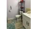 Bathroom with modern sink and cabinet, toilet with shelving unit, and neutral color scheme at 6808 Summer Time Dr, Indianapolis, IN 46226