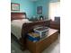Primary bedroom showcasing an ornate wood sleigh bed, dresser, and blue walls at 6808 Summer Time Dr, Indianapolis, IN 46226
