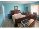 Primary bedroom showcasing an ornate wood sleigh bed and light-filled window at 6808 Summer Time Dr, Indianapolis, IN 46226