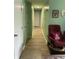 Hallway features a comfy chair and decorative items along the walls at 6808 Summer Time Dr, Indianapolis, IN 46226