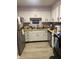 Galley kitchen features white cabinetry, stainless steel appliances, and wood-look flooring at 6808 Summer Time Dr, Indianapolis, IN 46226
