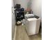 Functional laundry space with modern washer, shelving, and water heater for efficiency at 6808 Summer Time Dr, Indianapolis, IN 46226