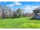 A well-maintained lawn, mature trees, and a charming screened porch offer a relaxing outdoor space at 7233 Capel Dr, Indianapolis, IN 46259