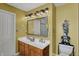 Bathroom featuring double vanity with modern lighting and a neutral color scheme at 7233 Capel Dr, Indianapolis, IN 46259