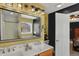 Bright bathroom with double vanity, modern lighting, and shower at 7233 Capel Dr, Indianapolis, IN 46259