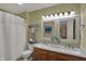 Bathroom featuring double sinks, a shower with curtain, and decorative accents at 7233 Capel Dr, Indianapolis, IN 46259