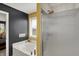 Bright bathroom with a soaking tub and shower featuring modern fixtures and a neutral color scheme at 7233 Capel Dr, Indianapolis, IN 46259