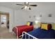 Bright bedroom with white twin beds, colorful bedding, and a ceiling fan at 7233 Capel Dr, Indianapolis, IN 46259
