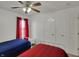 Bright bedroom with white twin beds, colorful bedding, and a ceiling fan at 7233 Capel Dr, Indianapolis, IN 46259