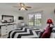 Bedroom with a black and white patterned bedspread, ceiling fan, and modern decor at 7233 Capel Dr, Indianapolis, IN 46259