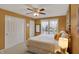 Cozy bedroom featuring warm yellow walls, a queen bed, and a ceiling fan at 7233 Capel Dr, Indianapolis, IN 46259