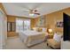 Cozy bedroom featuring warm yellow walls, a queen bed, and a ceiling fan at 7233 Capel Dr, Indianapolis, IN 46259