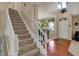 Welcoming foyer featuring a staircase and views of the dining area, creating an open and inviting entrance at 7233 Capel Dr, Indianapolis, IN 46259