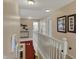 Bright hallway with white railing, neutral walls and decor leads to bedrooms and bathroom at 7233 Capel Dr, Indianapolis, IN 46259