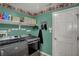 Efficient laundry room equipped with modern washer and dryer, shelving, and convenient storage solutions at 7233 Capel Dr, Indianapolis, IN 46259