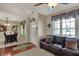 Open living space with hardwood floors, sofa, view to the dining room, and front door at 7233 Capel Dr, Indianapolis, IN 46259