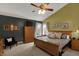 Spacious main bedroom featuring a ceiling fan, sitting area, and natural light at 7233 Capel Dr, Indianapolis, IN 46259