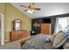 Cozy main bedroom featuring a ceiling fan, sitting area, and natural light at 7233 Capel Dr, Indianapolis, IN 46259
